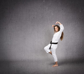 Fototapeta na wymiar karate girl ready to hit in a profile side