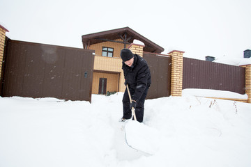 Man cleans snow shoveling