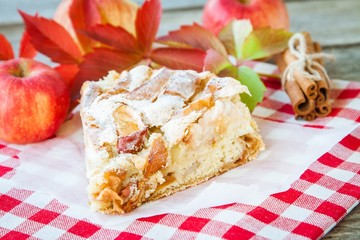 piece of apple pie on a wooden background