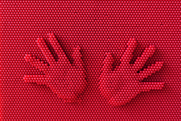 Left and right hand on red toys pin print