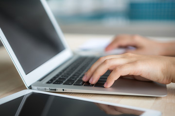Fototapeta na wymiar Closeup of business woman hand typing on laptop keyboard