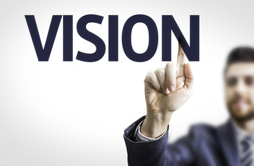 Business man pointing to transparent board with text: Vision