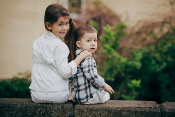 small sister and brother hugging