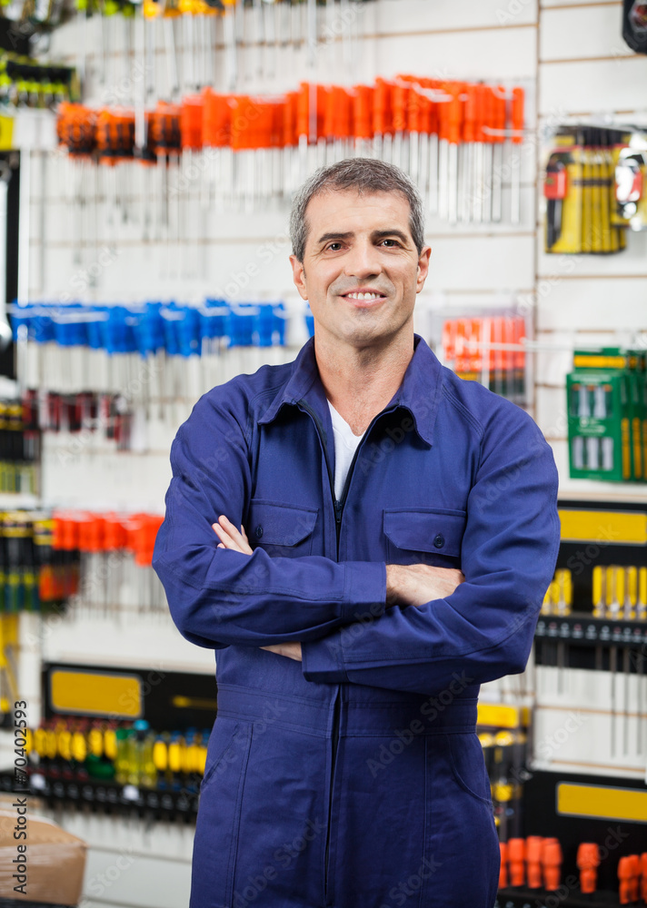 Wall mural worker with arms crossed in hardware store