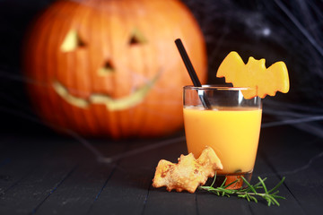 Glass of orange juice decorated for Halloween