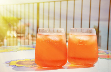 Traditional Italian Spritz cocktail against lake Como, Italy