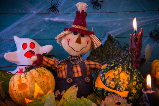 Halloween decoration with scarecrow and candles