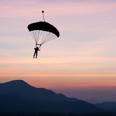 parachute at sunset silhouetted