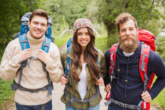 Group Of Smiling Friends With Backpacks Hiking