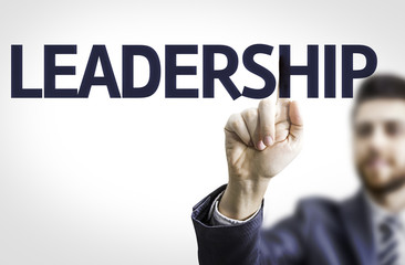 Business man pointing to transparent board with text: Leadership