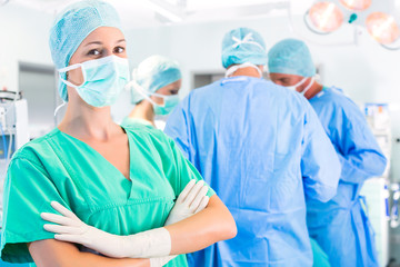 Surgeons operating patient in operation theater
