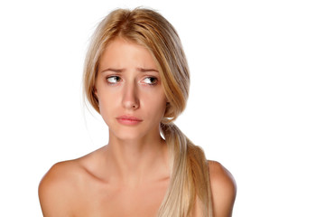 dissatisfied and sad young blonde on white background