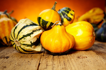 Decorative pumpkins on old wooden table
