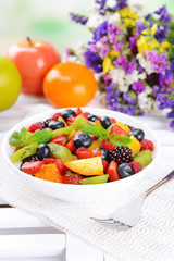 Delicious fruits salad in plate on table close-up