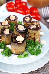 Fried aubergine with cottage cheese in a round plate