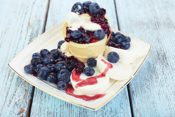 Tasty dessert with fresh blueberries on wooden table