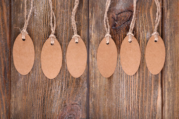 Brown tags on wooden background