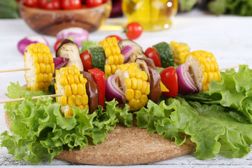 Sliced vegetables on picks on board on table close-up