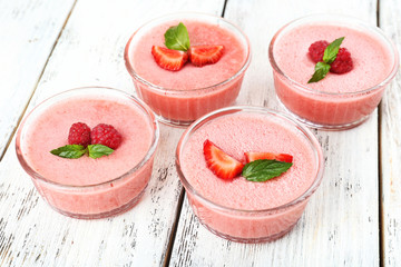Delicious berry mousse in bowls on table close-up