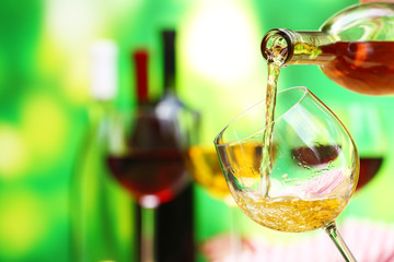 Red wine pouring into wine glass, close-up