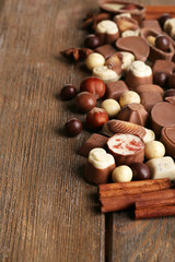 Different kinds of chocolates on wooden table close-up