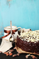 Tasty chocolate cake with almond, on old wooden table