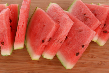 Slices of watermelon on wooden background