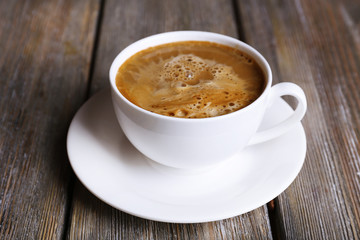 Cup of coffee with milk on wooden background