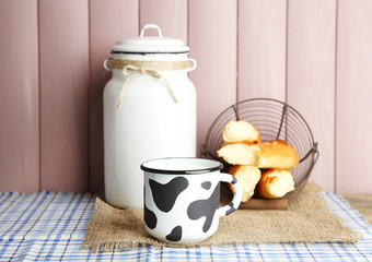 Retro still life with tasty rustic milk, on table