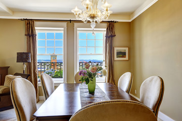 Dining table with flowers and city view through the window
