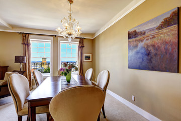 Dining table with flowers and city view through the window