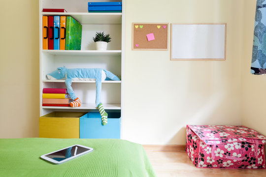 Colorful kids room with white bookcase
