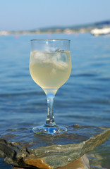 Glass of white wine by the coast