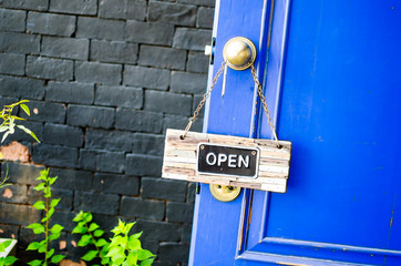 open label hanging on blue door in garden