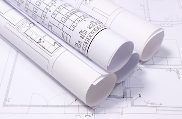 Rolled electrical diagrams on construction drawing of house