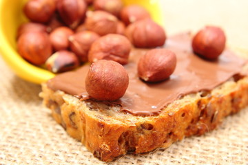 Hazelnut and slices of bread with chocolate cream