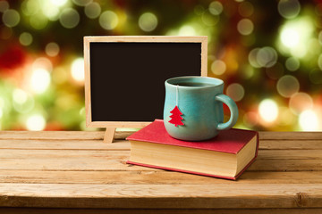 Tea and books with chalkboard over Christmas background