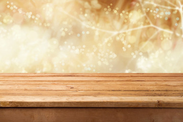 Golden bokeh background with empty wooden table