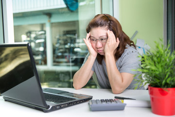 Asian serious women using laptop computer .