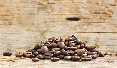 coffee grains on grunge wooden background