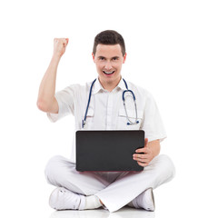 Happy male medicine student with a laptop