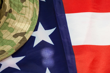 US flag with camouflage combat hat