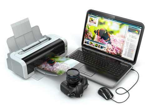 Laptop, photo camera and printer. Preparing images for print.