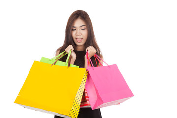 Beautiful Asian woman  surprise with  shopping bags in both hand