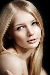 Obraz premium Woman face close up. A pretty young blond trendy. Girl with a be