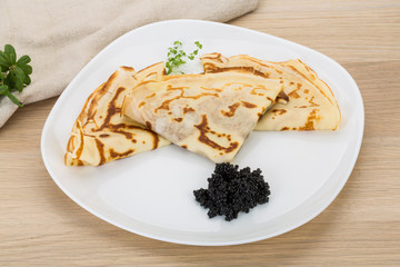 Pancakes with black caviar