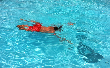 Young teenage boy swimming