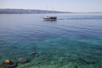 Fototapeta premium Wooden sailing boat with two masts near coastline of Brac island