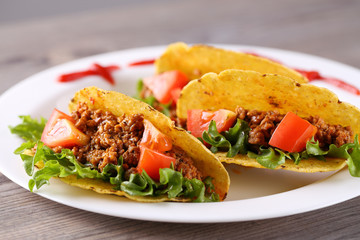 three taco shells on the plate