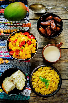 salad of mango and tomato with red lentils with curry and dates